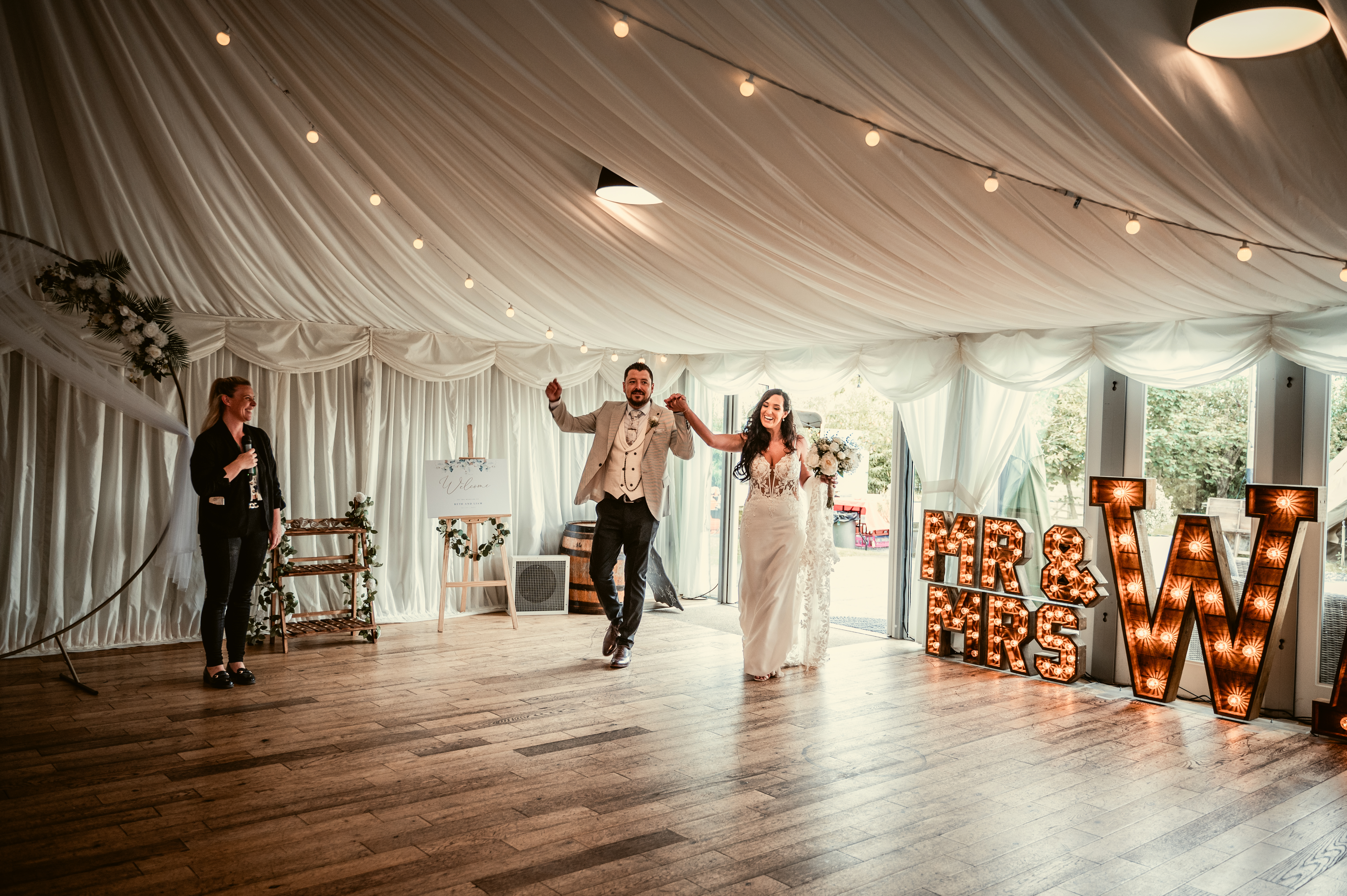 Couple entering the barn dance floor, ready to party, with our very own Wedding Manager Lyndsey introducing. The prime Mr and Mrs shot!